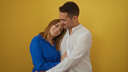 Man and woman embracing lovingly against a yellow background, illustrating a warm, beautiful...