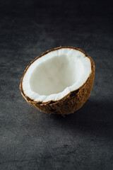 Fresh Coconut Half on Dark Background Isolated with Detailed Texture and Natural Colors