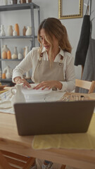 Young blonde woman shapes clay with hands on potters wheel in bright studio space with concentrated expression; creativity focus.