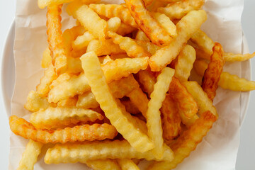 Crispy Golden French Fries on White Plate with Bright Neutral Background