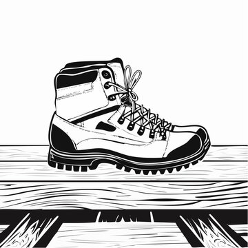 Hiking boots on wooden surface suggest readiness for outdoor adventure image vector.