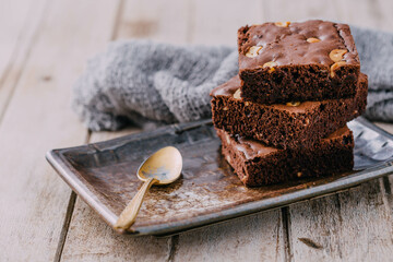 Chocolate Brownie Stacked on Plate with Spoon and Napkin