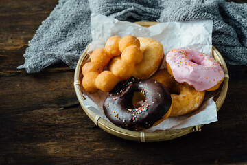 Assortment of Colorful Donuts on a Rustic Wooden Table
