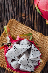 Fresh Dragon Fruit Slices on Rustic Wooden Surface with Texture