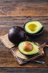 Fresh Avocado Halves on Wooden Cutting Board with Rustic Setting