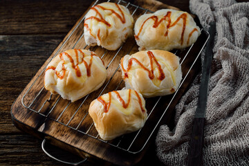 Freshly Baked Buns with Condiments on Wooden Cutting Board