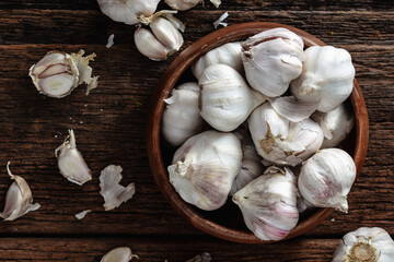 Fresh Garlic Bulbs in Wooden Bowl on Rustic Wooden Table