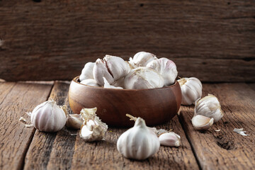 Fresh Garlic Cloves in Wooden Bowl on Rustic Wooden Table