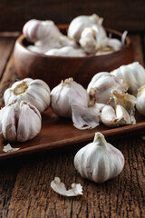 Fresh Garlic Bulbs and Cloves on Wooden Surface in Rustic Setting