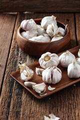Fresh Garlic Cloves on Wooden Table with Rustic Bowl Display