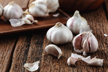 Fresh Garlic Bulbs and Cloves on Rustic Wooden Table Surface