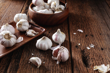 Fresh Garlic Bulbs and Cloves on Wooden Table with Rustic Background