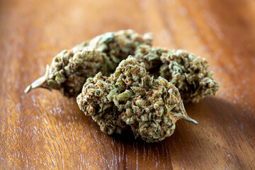 Close-Up View of Dried Cannabis Buds on Wooden Surface