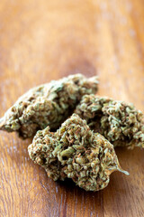Close-Up of Natural Cannabis Buds on Wooden Surface