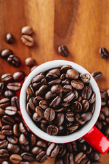 Freshly Roasted Coffee Beans in Red Mug on Wooden Surface Above