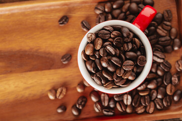 Freshly Roasted Coffee Beans in Red Cup on Wooden Tray