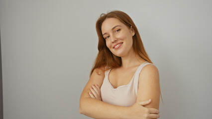 Fototapeta premium Woman smiling confidently isolated on white background, showcasing her red hair and beauty in a simple and elegant pose, embodying charm and modern simplicity.