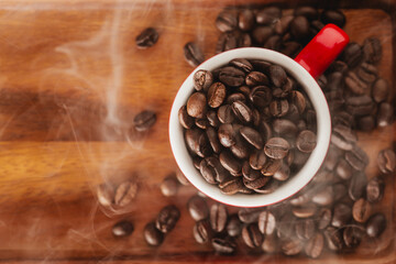 Freshly Roasted Coffee Beans in Red Cup on Wooden Surface