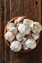 Fresh Garlic Bulbs in Wooden Bowl on Rustic Wooden Table