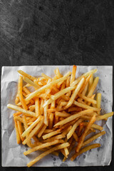 Delicious Golden French Fries on White Paper Background