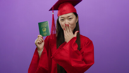 Woman in red graduation gown holding chinese passport against a purple background, symbolizing...