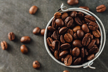 Fresh Roasted Coffee Beans in Metal Bucket on Dark Surface