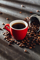 Freshly Brewed Coffee in a Red Cup Surrounded by Coffee Beans