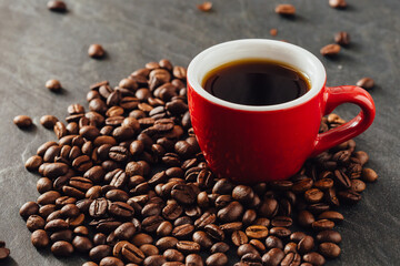 Fresh Brewed Coffee in Red Cup Surrounded by Dark Coffee Beans