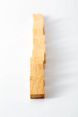 Wooden Blocks in a Straight Line on a White Background