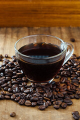 Freshly Brewed Coffee in Glass Cup Surrounded by Coffee Beans