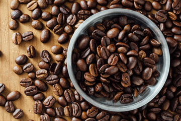 Organic French Roast Coffee Beans in Silver Bowl on Wooden Table