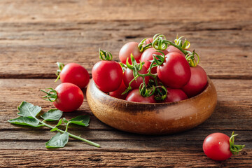 Fresh Cherry Tomatoes in Wooden Bowl on Rustic Wooden Background