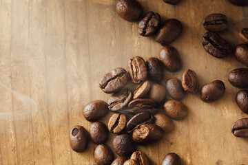 Freshly Roasted Coffee Beans on Wooden Surface with Smoke Effect