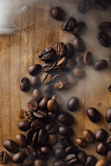 Freshly Roasted Coffee Beans on Wooden Surface with Wisps of Steam
