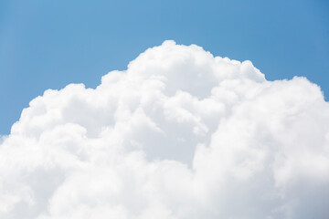 Large Fluffy White Clouds Against Clear Blue Sky Background
