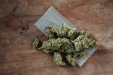 Freshly harvested cannabis buds on rustic wooden background