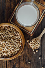 Fresh Soybeans and Glass of Creamy Soy Milk on Rustic Wooden Table