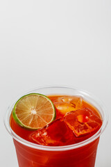 Refreshing Citrus Beverage with Ice and Lime Slice in Glass