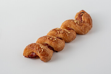 Flaky Pastry Roll with Sweet Filling and Nuts on White Background