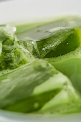 Refreshing Green Jelly in Clear Bowl with Ice Cubes and Liquid