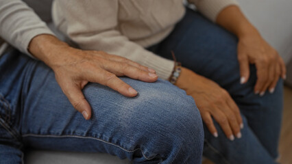 Middle-aged couple sitting on couch at home showing love and togetherness in a cozy living room setting, highlighting intimate moments of elderly man and woman indoors.