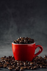 Red Coffee Cup Overflowing with Fresh Roasted Coffee Beans