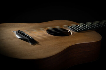 Close-up Capture of Elegant Acoustic Guitar Body on Black Background