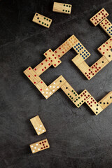 Wooden Domino Game Pieces on Dark Surface in Stylish Arrangement