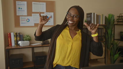 Woman smiling in an office setting with a professional atmosphere, featuring a young female with...