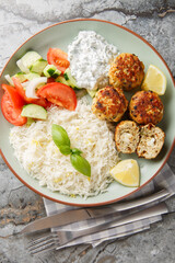 Chicken meatballs with sun-dried tomatoes, feta cheese and aromatic spices served with lemon rice...