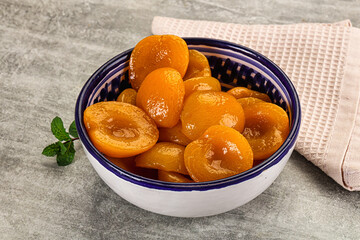 Sweet canned apricots with syrope