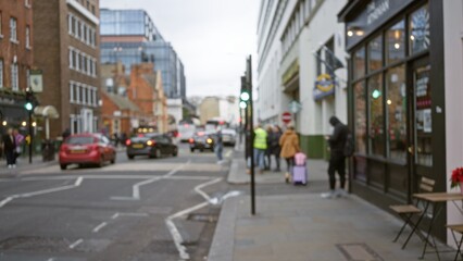 Blurred street scene in london during winter with people, cars, and buildings, highlighting urban life in the uk with defocused elements and bokeh effect.