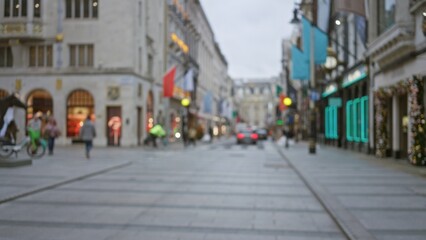 London street scene in winter with blurred pedestrians, festive decorations, and vibrant shopfront lights creating a cozy atmosphere under a cloudy sky.