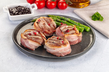 Tasty grilled pork medallion with bacon
